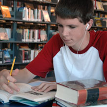 High School Boy Working in Library