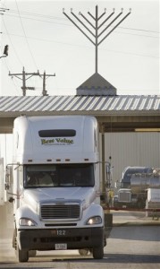 That's right: that's a Jewish menorah, prominently displayed atop the reopened meat-processing plant.  (AP Photo/Charlie Neibergall)