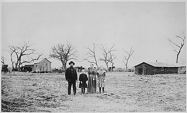 
Residence of G. L. Rule Feb. 18, 1898. Have lived here since Sept. 1893. Family stands in foreground; sod building and cabin in background, Arizona Territory
From the Series: Photographs Accompanying Reports to the  Secretary of the Interior
