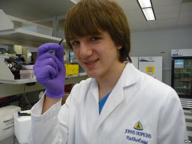 Jack Andraka, 16, with his pancreatic cancer sensor strip at the Johns Hopkins lab in Baltimore. (Courtesy Jane Andraka)
