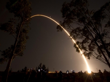 An arc of light illuminates the pre-dawn sky at Vandenberg Air Force Base, Calif., as a Delta II rocket launches with the NPOESS Preparatory Project (NPP) spacecraft payload.