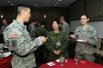 Japanese Ground Self-Defense Force Sgt. Mari Yoshida, center, assigned to the 4th Engineer Group of the Eastern Army, takes part in a reception for Co-Op Class No. 67 at the Camp Zama Community Club on Jan. 15. With Yoshida are her sponsor, 2nd Lt. Rachel Stone, right, assigned to the 35th Combat Sustainment Support Battalion, and Capt. William Gumabon, assigned to U.S. Army Japan.