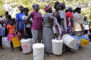 Displaced Haitians wait in line for fresh water supply at a refugee camp in Port-au-Prince. January 21, 2010.