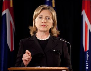 Secretary Clinton gestures behind podium (AP Images)