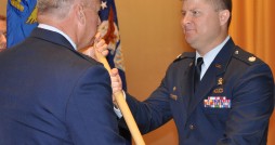 Lt. Col. Daren Van Aulen (right) takes his new unit's guidon from Commander of the Florida Air National Guard Brig. Gen. Joseph Balskus, July 22, 2012, at MacDill Air Force Base. Van Aulen assumed command of the 290th Joint Communications Support Squadron from Lt. Col. Loretta Lombard. Photo by Master Sgt. Thomas Kielbasa