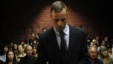 Oscar Pistorius stands in the dock ahead of court proceedings at the Pretoria magistrates court Feb. 22, 2013. 