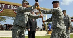 Florida Army National Guard State Command Sgt. Maj. Robert Hosford (right) passes the Florida National Guard guidon to Adjutant General of Florida Maj. Gen. Douglas Burnett during the change of command ceremony at Camp Blanding Joint Training Center, Fla., June 26, 2010. Photo by Master Sgt. Thomas Kielbasa