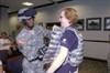 FORT MCPHERSON, Ga. (August 18, 2009) ? Maj. Amanda Azubuike, Third Army/U.S. Army Central PAO, assists Lisa Stephens try on her body armor during a visit to Third Army?s headquarters at Fort McPherson, Ga., Aug. 18. The visit was part of the Honorary Commander?s Tour which gives local business leaders the opportunity to tour units in order to get a better understanding of military life. Photo by Sgt. Beth Lake, Third Army/USARCENT Public Affairs.