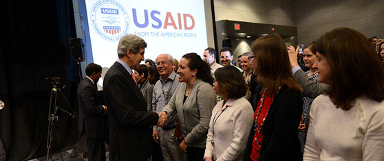 U.S. Secretary of State John Kerry speaks with U.S. Agency for International Dev