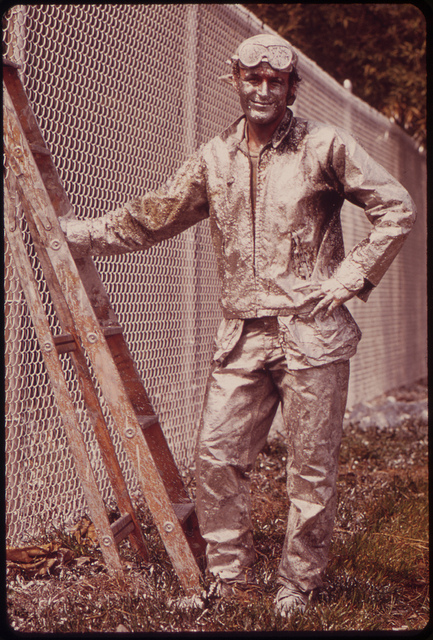 DOCUMERICA: Painter Working On Chain Link Fence, August 1973 Dick Swanson.