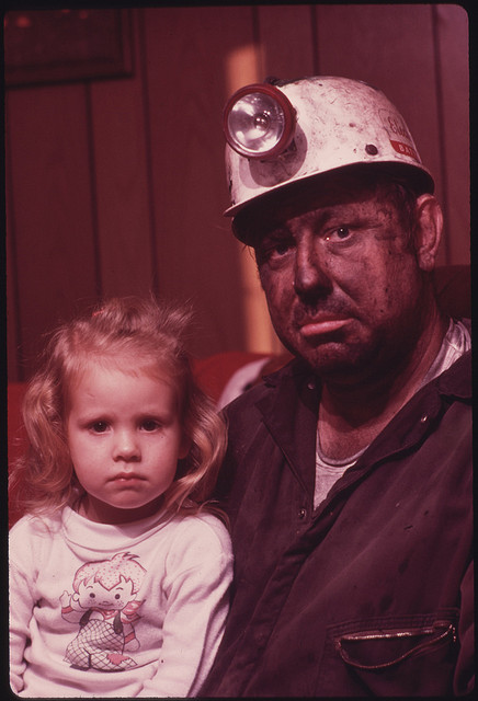 DOCUMERICA: Miner Wayne Gipson, 39, with His Daughter Tabitha, 3. He Has Just Gotten Home From His Job as a Conveyor Belt Operator in a Non-Union Mine. as Soon as He Arrives He Takes a Shower and Changes Into Clothes to Do Livestock Chores with His Two Sons. Gipson Was Born and Raised in Palmer, Tennessee, But Now Lives with His Family near Gruetli, near Chattanooga. He Moved North to Work and Married There, But Returned Because He and His Wife Think It Is a Better Place to Live. December, 1974 by Jack Corn.