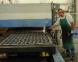 A worker uses the current cutting laser at Precise Fabrication of Beatrice, Neb.