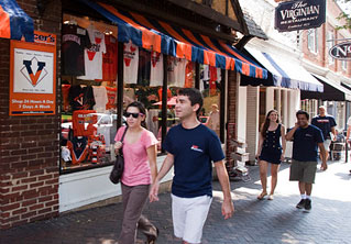 students walk along the stretch of shops, cafes, and night spots.