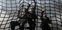 Soldiers climbing cargo net obstacle