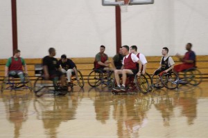 BG Cheek (right of center) plays wheelchair basketball with Wounded Warriors.