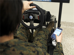 A Marine with Headquarters and Headquarters Squadron, , attempts to text while driving in a simulator at a class held by AT&T’s “It Can Wait” campaign aboard Marine Corps Air Station Miramar, Calif., Jan. 10. Distracted driving is a factor in a quarter of police accident reports in the United States.