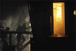 Aircraft Rescue Fire Fighting Marines rush into an simulated aircraft to put out a fire during a fire training evolution at the Marine Corps Air Facility aboard Quantico on Feb. 12. The Marines went in groups of three when attempting to put out the fire inside of the simulated aircraft.