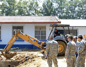 TATIC, Guatemala - Soldiers in support of Beyond the Horizon Guatemala 2012 survey construction of a new medical clinic as a Guatemalan contractor excavates the existing structure.