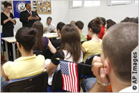 Woman with notepad and King standing in front of classroom (AP Images)