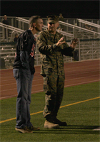 Col. John P. Farnam, left, the commanding officer of Marine Corps Air Station Miramar, Calif., and Lt. Col. Daniel J. Levasseur, right, the commanding officer of Headquarters and Headquarters Squadron, watch a playoff game against the 11th Marine Regiment Cannon Cockers from the sidelines at the Paige Field House football field aboard Marine Corps Base Camp Pendleton, Calif., Nov. 6. The Falcons won the game and will be playing for the Camp Pendleton Football League Championships on Nov. 20. 