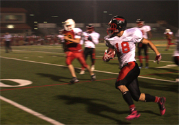 Cpl. Wiley Flowers, a quarterback with the Marine Corps Air Station Miramar Falcons and a Philadelphia, Pa., native, runs down the field after catching an interception during a playoff game against the 11th Marine Regiment Cannon Cockers at the Paige Field House football field aboard Marine Corps Base Camp Pendleton, Calif., Nov. 6. This is the eighth straight win for the Falcons with a final score of 9-6. 