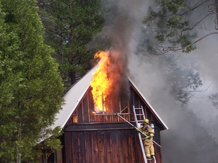 Yosemite structural firefighters vent a house during a training in March, 2009.