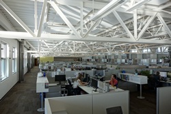 Photo of NREL Commercial Buildings team members Jennifer Scheib and Matt Leach working in cubicles lit entirely by daylight in the Research Support Facility.