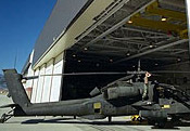 Photo of a SolarWall solar ventilation air preheating system on the AVUM helicopter maintenance hangar at Fort Carson U.S. Army Base that links to the NREL Department of Defense energy programs Web page.