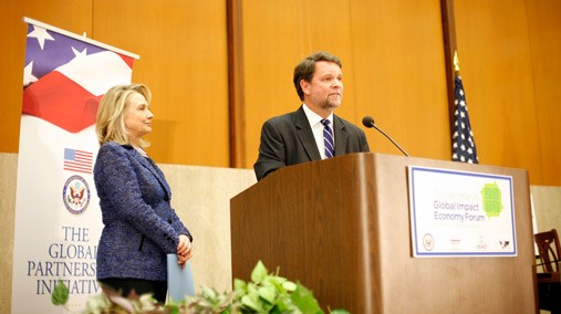 Special Representative for Global Partnerships Kris Balderston introduces U.S. Secretary of State Hillary Rodham Clinton at the first-ever Global Impact Economy Forum at the U.S. Department of State in Washington, D.C., on April 26, 2012. [State Department photo by Ben Chang/ Public Domain]