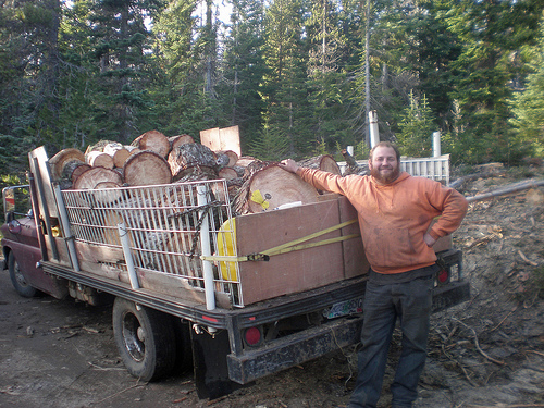 A firewood gatherer stands proudly with his truck load of cut firewood from the Mt. Hood National Forest in Oregon. More than 600 cords of wood were cut and cleared from the Barlow Ranger District in partnership with Wasco County, Oregon. (U.S. Forest Service Photo)