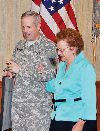 Brig. Gen. Donald MacWillie, senior commander, Fort Riley, left, escorts 91-year-old Marie Cundiff, Junction City, right, back to her seat after receiving the Helping Hand Award Jan. 29 at Riley’s Conference Center. Cundiff handwrote and mailed hundreds of cards and letters to Fort Riley Soldiers.  Photo by: Calun Reece, POST.