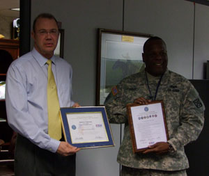 Mr. Wakeman and Col. Johnson hold their plaques up that were presented by the ESGR for their appreciation