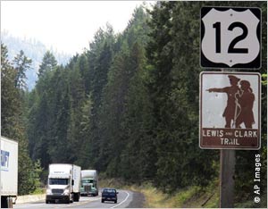 Mountain road with highway sign in foreground (AP Images)