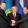 From left to right, presidents Yanukovych, Nazarbayev, and Mevedev embrace and smile. (AP Images) 