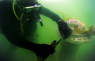 Navy Diver 2nd Class Devon Headley, assigned to Mobile Diving Salvage Unit (MDSU) 2, removes the transducer head from a sonar buoy during dive operations. MDSU-2 is deployed with Commander, Task Group 56.1, which provides mine counter-measures, explosive ordnance disposal, salvage-diving, counterterrorism, and force protection for the U.S. 5th Fleet.  U.S. Navy photo by Mass Communication Specialist 1st Class Shane Tuck (Released)  120419-N-IZ904-107