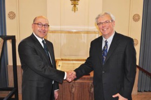 Ambassador Jacobson shakes hands with Manitoba Premier Greg Selinger in front of the Magna Carta