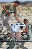 Lance Cpl. Brandon Tafoya, and Sgt. Dane A. Hayes, both Unmanned Aerial Vehicle mechanics with Marine Unmanned Aerial Vehicle Squadron 1, prepare a RQ-7B Shadow 200 for a flight aboard Marine Corps Base Camp Pendleton, July 27. The Marine Air Ground Combat Center Twentynine Palms-based squadron had the rare opportunity to train with Pendleton units during their stay here.  (Official U.S. Marine Corps photo by Cpl. Christopher O'Quin)(Released)