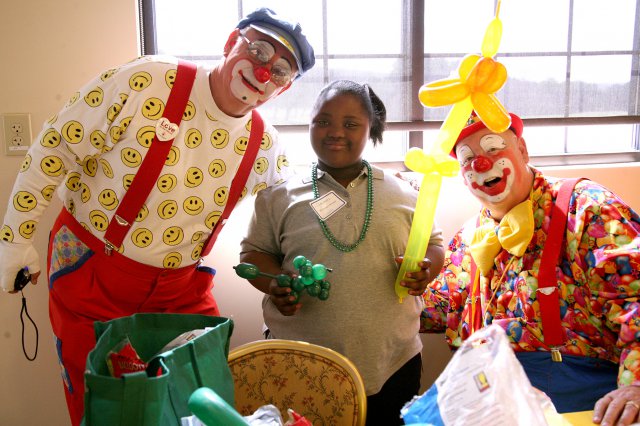 Huntsville Cahaba Shriners clowns pose for a photo after creating balloon designs for a surviving family member during the Survivor Outreach Services Mardi Gras at The Overlook on Redstone Arsenal, Ala., Feb. 9, 2013. The event was sponsored by SOS and the U.S. Army Space and Missile Defense Command.