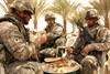 BAGHDAD, Iraq (May 14, 2008) - U.S. Army Spc. Timothy Russell, 1st Lt. Ryan Clay, and Spc. Eric Waddle enjoy Iraqi cuisine provided by a local sheik during a meeting between coalition and local leaders in the East Anbar province, northwest of Baghdad, May 8, 2008. Russell and Waddle are assigned to the 25th Infantry Division's Headquarters and Headquarters Company, 1st Battalion, 2nd Stryker Brigade Combat Team, Multinational Division - Baghdad. Clay is assigned to the 27th Infantry Regiment's Headquarters and Headquarters Co. Photo by Staff Sgt. J.B. Jaso III, U.S. Army.   