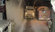 Vehicles pass within inches of each other through the darkened Salang Tunnel in Parwan province, Afghanistan.  While there are other routes through the Hindu Kush, the tunnel is the quickest, most efficient road and deemed most protected from insurgent attacks.  (Photo by Staff Sgt. Derek M. Smith, 411th Engineer Brigade)