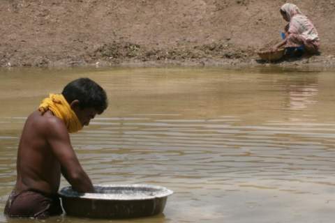 Photo of husband and wife building fish pond for fish farming