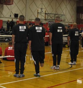 Members of Army Platoon 1 stand for the National Anthem before the sitting volleyball competition begins. 