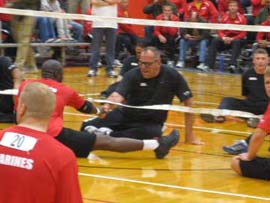 Photo Caption: SGT David Marklein offers a warm handshake to a Marine during an early sitting volleyball game.  SGT Marklein's sportsmanship embodies the true spirit of the Warrior Games – wounded warriors from all services supporting each other in celebration of the their abilities.