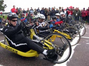 SPC Michael Ortiz (far left) and SSG Alfred Delossantos (second from left) cross the start line in the 10K handcycle race.