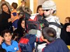 BAGHDAD, Iraq (June 13, 2008) - Cpl. Brandi Tennison, 64th Military Police Company, who is a native of Dallas, hands out school supplies to local children of Hurriyah on June 12. The 64th MP Co., is deployed from Fort Hood, Texas, and is currently assigned to the 716th MP Battalion, 18th MP Bde., MND-B. Photo by Sgt. Daniel Blottenberger, Multi-National Division Baghdad.