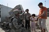 SADR CITY, Iraq (June 13, 2008) - U.S. Army SSG Frank J. Lugo, a native of New York City, N.Y., and a member of the Task Force Regulars 1st Brigade, 6th Infantry Division Civil Affairs Team gives a friendly pat on the head of an Iraqi boy after giving him and his friends Blowpops while patrolling Market in the Sadr City district of Baghdad on June 13, 2008. SSG Lugo is deployed from the 404th Civil Affairs Airborne Battalion in New Jersey. Photo by Tech Sgt. Cohen A. Young, U.S. Air Force.