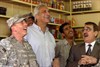 HAWIJAH, Iraq (June 14, 2008) - Army Gen. David Petraeus, left, commanding general of Multinational Force Iraq, watches as Iraq scores a goal during a televised soccer match in a shop in Hawijah, Iraq, June 14, 2008. This was Petraeus' first visit to this northeastern city, which has seen a 90 percent drop in violent activity in recent months. Photo by Staff Sgt. Margaret C. Nelson, U.S. Army. 