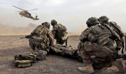 Photo: Security force team members for Provincial Reconstruction Team (PRT) Farah wait for a UH-60 Blackhawk MEDEVAC helicopter to land before moving a simulated casualty during medical evacuation training on FOB Farah, Jan. 9. U.S. Navy photo by HMC Josh