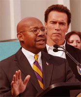 [Photo: Secretary Jackson announcing funding with Governor Arnold Schwarzenegger]