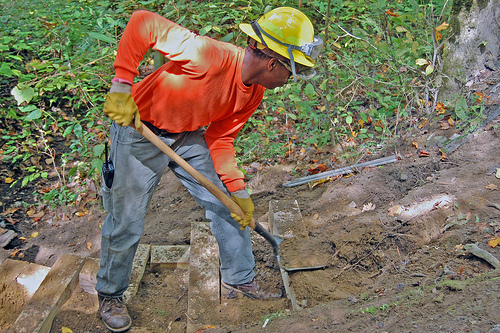 North Carolina Forest Service Job Corps students improve historic site. Forest Service Job Corps student Jay Williams digs out a new footer for the next step in a stairway for increased angler access along Santeetlah Creek on the Nantahala National Forest on Sept. 29, 2012. US Forest Service photo/Holly Krake.